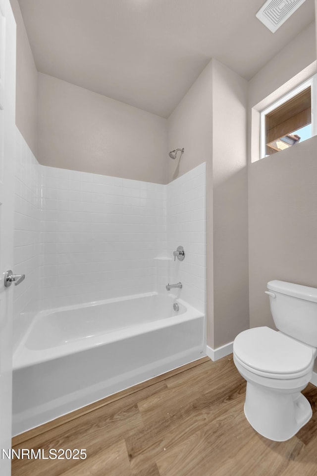 1466 Copper Point Cir, Reno, NV 89519 - bathroom with toilet, shower / washtub combination, wood finished floors, and baseboards