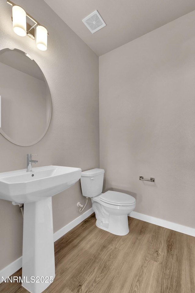1466 Copper Point Cir, Reno, NV 89519 - bathroom with toilet, wood finished floors, baseboards, and a sink