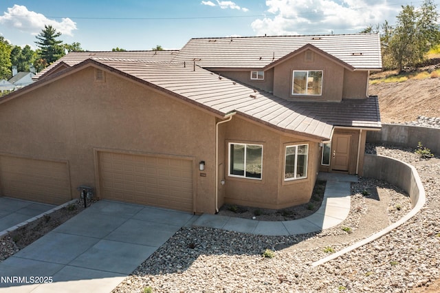 1466 Copper Point Cir, Reno, NV 89519 - rear view of property with stucco siding, a garage, and driveway