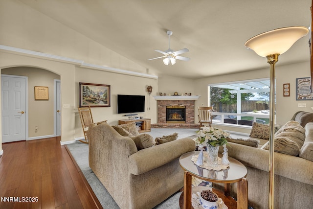 2866 La Cresta Cir, Minden, NV 89423 - living room with a ceiling fan, hardwood / wood-style floors, a brick fireplace, lofted ceiling, and arched walkways