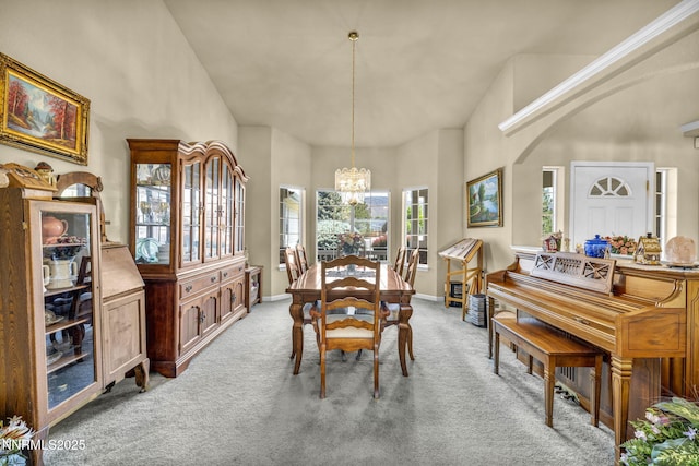 2866 La Cresta Cir, Minden, NV 89423 - dining space featuring light colored carpet, a chandelier, a towering ceiling, and baseboards