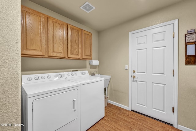 2866 La Cresta Cir, Minden, NV 89423 - laundry room with cabinet space, washer and clothes dryer, light wood-type flooring, and baseboards