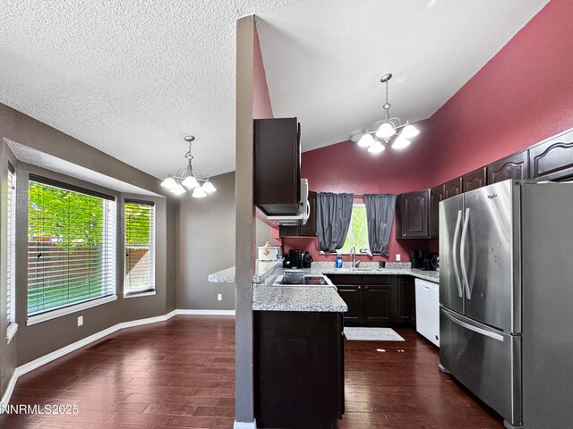 620 W National Ave, Winnemucca, NV 89445 - kitchen with a chandelier, freestanding refrigerator, dishwasher, dark wood-type flooring, and lofted ceiling