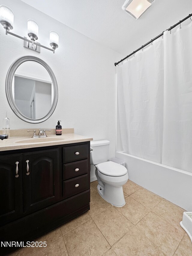 620 W National Ave, Winnemucca, NV 89445 - full bath with vanity, toilet, shower / bath combo, tile patterned floors, and vaulted ceiling