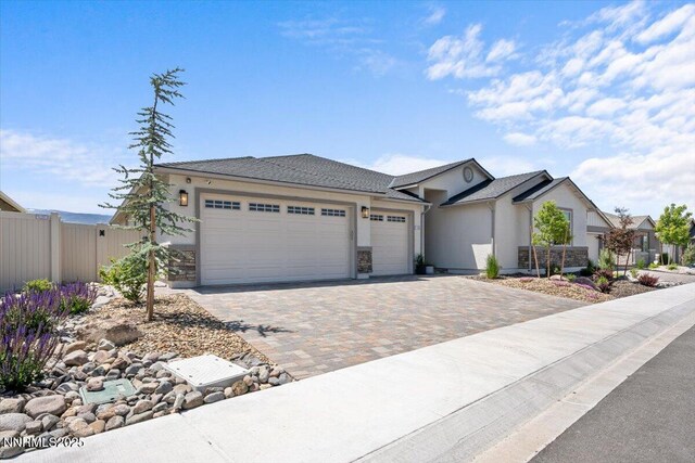 11235 Freedom Range Ln, Reno, NV 89521 - single story home with an attached garage, decorative driveway, and stucco siding