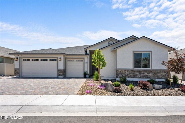 11235 Freedom Range Ln, Reno, NV 89521 - single story home with stone siding, stucco siding, a garage, and driveway
