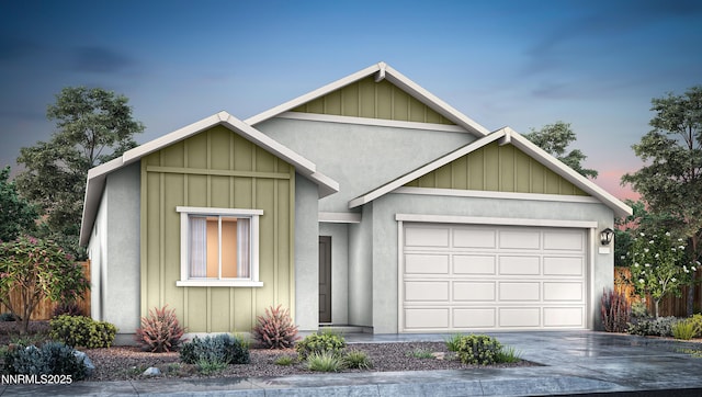 4570 Langdon St, Fernley, NV 89408 - view of front of property featuring concrete driveway, an attached garage, and board and batten siding
