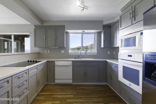 16360 Jefte Ct, Reno, NV 89511 - kitchen featuring white appliances, gray cabinetry, and rail lighting
