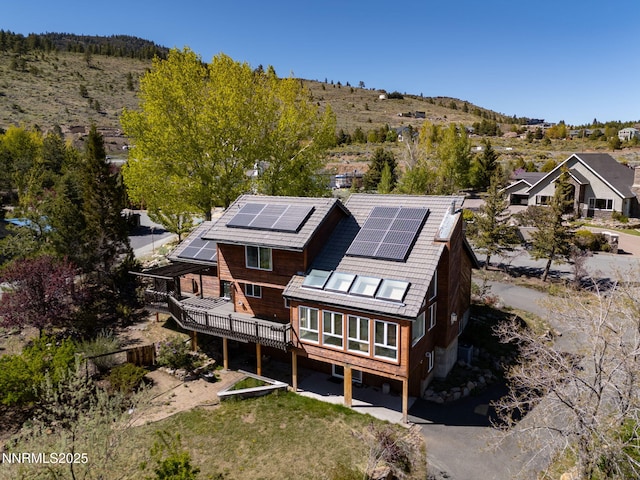 16360 Jefte Ct, Reno, NV 89511 - back of house featuring roof mounted solar panels and a wooden deck
