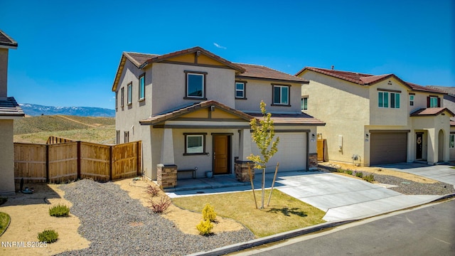 2040 Painted Sky Way, Sun Valley, NV 89433 - view of front of property featuring a garage, concrete driveway, stucco siding, a tile roof, and a mountain view
