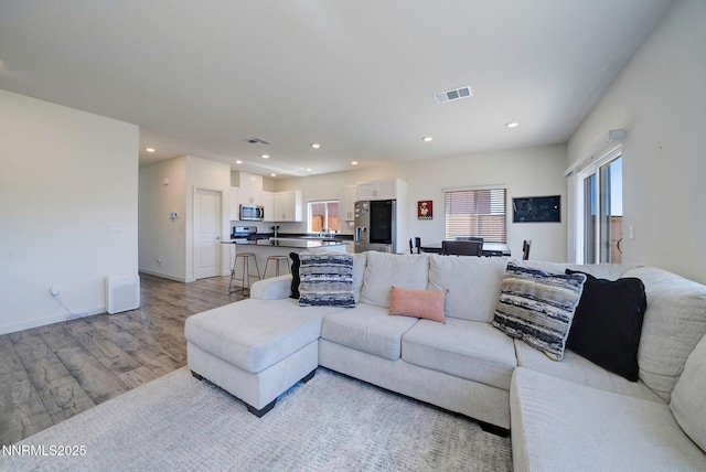 2040 Painted Sky Way, Sun Valley, NV 89433 - living room featuring light wood-style flooring, recessed lighting, and baseboards