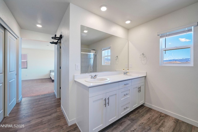 2040 Painted Sky Way, Sun Valley, NV 89433 - full bath with double vanity, a shower with door, wood finished floors, baseboards, and recessed lighting