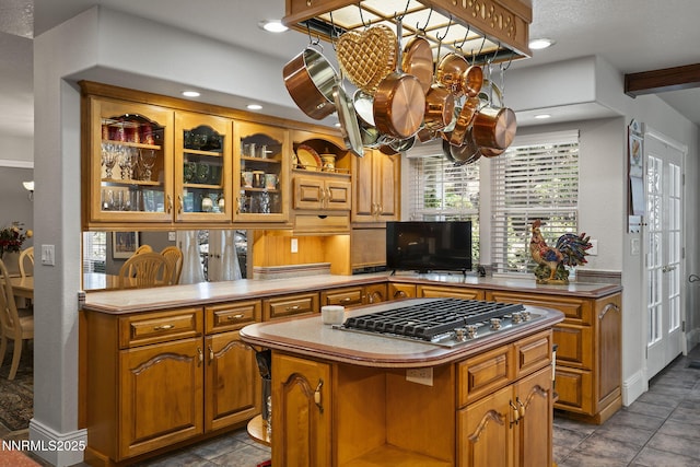 30 Francovich Ct, Reno, NV 89519 - kitchen featuring a chandelier, brown cabinetry, a center island, glass insert cabinets, and stainless steel gas stovetop
