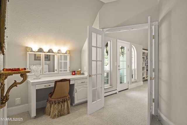 30 Francovich Ct, Reno, NV 89519 - office area with vaulted ceiling, light carpet, a baseboard heating unit, and built in desk