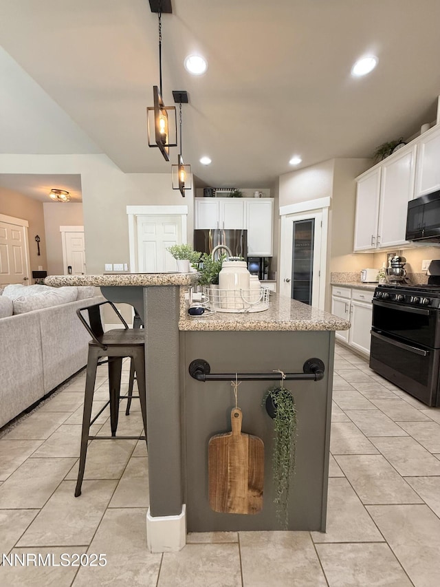 3221 Hackamore Way, Winnemucca, NV 89445 - kitchen featuring black appliances, white cabinets, light tile patterned floors, a kitchen breakfast bar, and recessed lighting