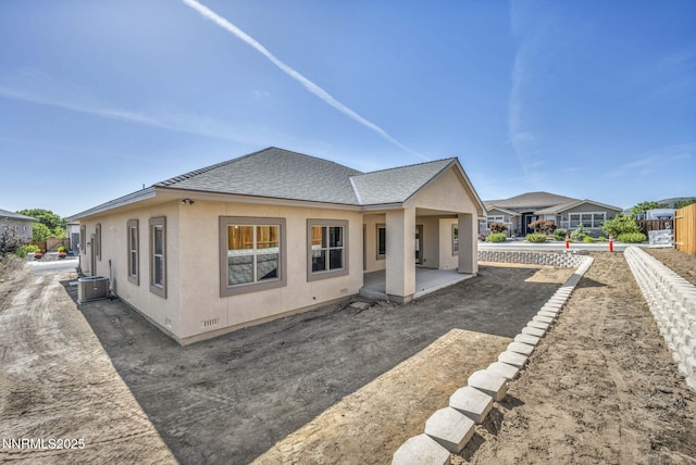 3952 Siena Dr, Carson City, NV 89703 - back of house featuring cooling unit, roof with shingles, stucco siding, and a patio area