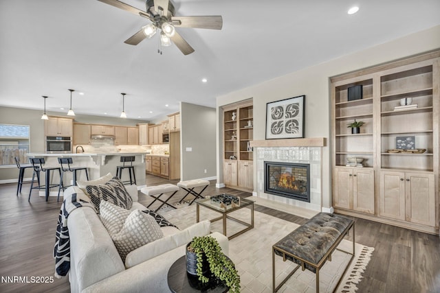 3952 Siena Dr, Carson City, NV 89703 - living room featuring baseboards, light wood-style flooring, recessed lighting, ceiling fan, and a tiled fireplace