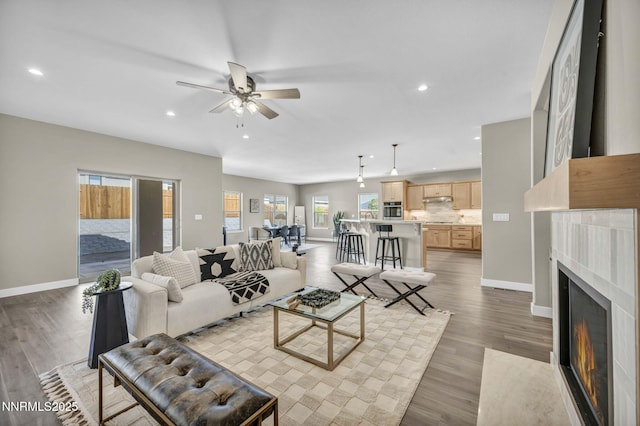 3952 Siena Dr, Carson City, NV 89703 - living room with a ceiling fan, baseboards, recessed lighting, a fireplace with flush hearth, and light wood-style floors