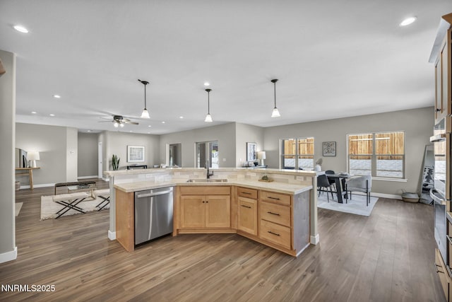 3952 Siena Dr, Carson City, NV 89703 - kitchen featuring dishwasher, a sink, baseboards, light countertops, and wood finished floors