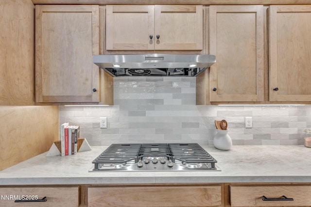 3952 Siena Dr, Carson City, NV 89703 - kitchen with light brown cabinetry, stainless steel gas stovetop, extractor fan, and light countertops