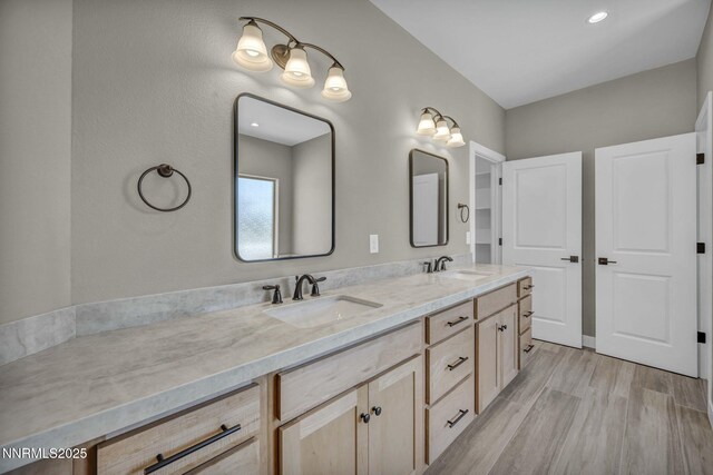 3952 Siena Dr, Carson City, NV 89703 - bathroom featuring double vanity and wood finished floors