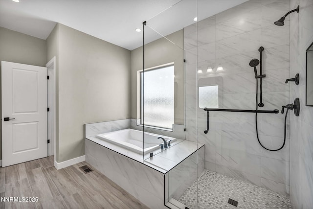 3952 Siena Dr, Carson City, NV 89703 - bathroom featuring a shower stall, a garden tub, baseboards, wood finished floors, and recessed lighting