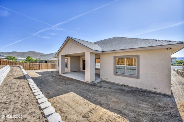 3952 Siena Dr, Carson City, NV 89703 - back of property featuring a patio area, stucco siding, a mountain view, and roof with shingles