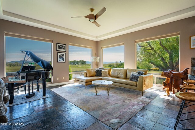2473 Genoa Aspen Dr, Genoa, NV 89411 - living area with stone tile floors, a ceiling fan, and baseboards