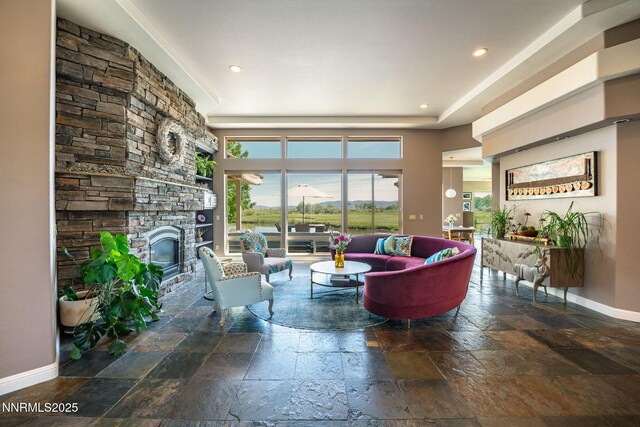 2473 Genoa Aspen Dr, Genoa, NV 89411 - living room with stone tile flooring, baseboards, a stone fireplace, healthy amount of natural light, and recessed lighting