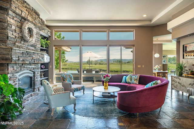 2473 Genoa Aspen Dr, Genoa, NV 89411 - living room with stone tile flooring, a fireplace, a high ceiling, and recessed lighting