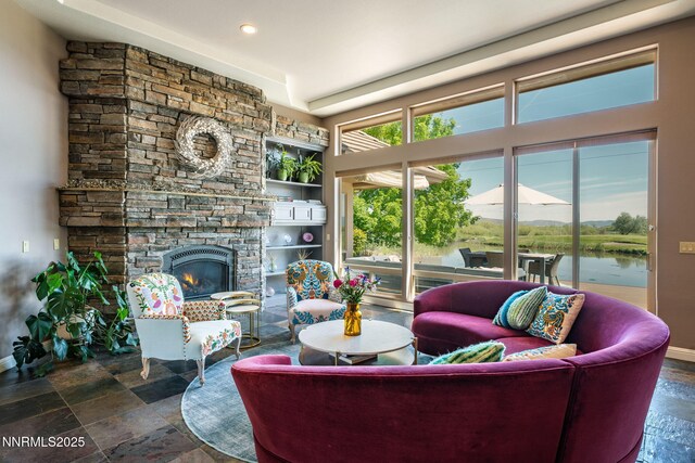 2473 Genoa Aspen Dr, Genoa, NV 89411 - living area with a fireplace, stone tile flooring, baseboards, recessed lighting, and a water view