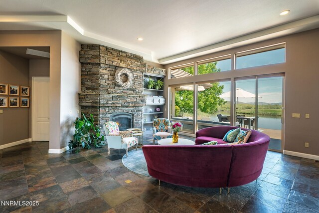 2473 Genoa Aspen Dr, Genoa, NV 89411 - living room featuring stone tile flooring, baseboards, a stone fireplace, and recessed lighting