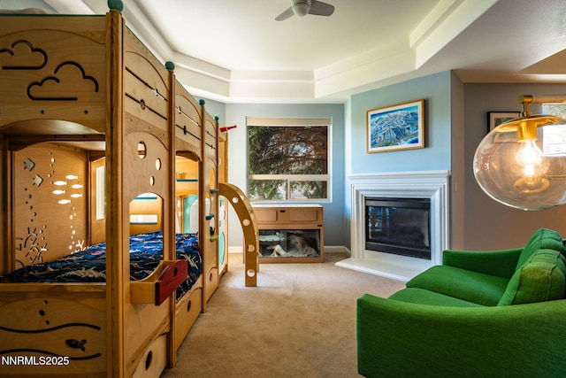 2473 Genoa Aspen Dr, Genoa, NV 89411 - bedroom with carpet floors, a tray ceiling, a glass covered fireplace, and baseboards