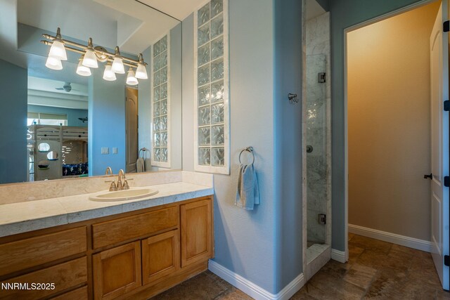 2473 Genoa Aspen Dr, Genoa, NV 89411 - bathroom with a shower stall, vanity, and baseboards