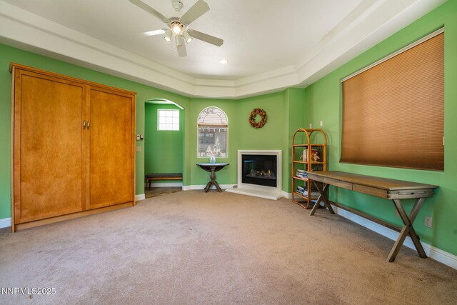 2473 Genoa Aspen Dr, Genoa, NV 89411 - sitting room featuring carpet flooring, a ceiling fan, arched walkways, baseboards, and a tray ceiling