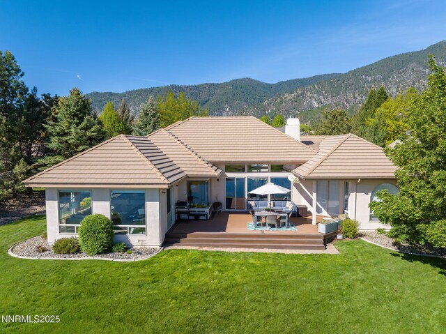 2473 Genoa Aspen Dr, Genoa, NV 89411 - rear view of house featuring a tile roof, a chimney, stucco siding, an outdoor hangout area, and a deck with mountain view