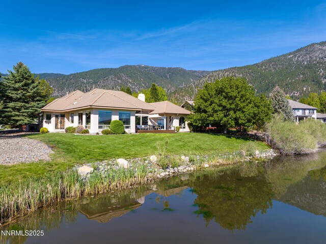 2473 Genoa Aspen Dr, Genoa, NV 89411 - back of house with a tiled roof, a yard, a chimney, and a water and mountain view