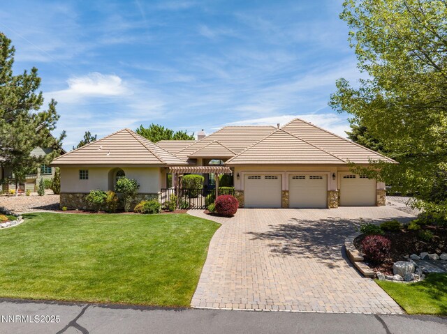 2473 Genoa Aspen Dr, Genoa, NV 89411 - single story home featuring stone siding, a garage, stucco siding, driveway, and a tiled roof