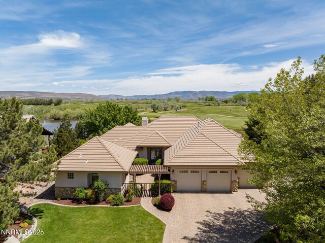 2473 Genoa Aspen Dr, Genoa, NV 89411 - view of front of property with stone siding, a tile roof, driveway, and an attached garage