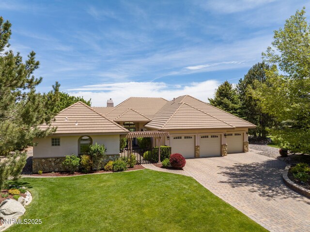 2473 Genoa Aspen Dr, Genoa, NV 89411 - ranch-style house featuring stone siding, driveway, a garage, a front yard, and stucco siding