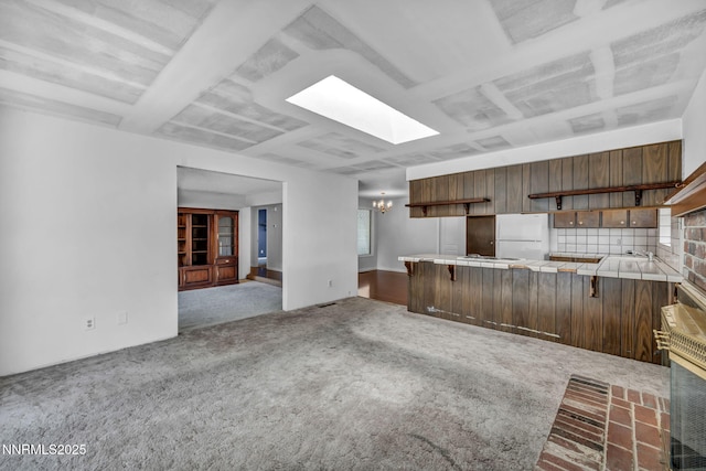 1129 Sonoma St, Carson City, NV 89701 - unfurnished living room featuring a skylight, carpet floors, and a chandelier