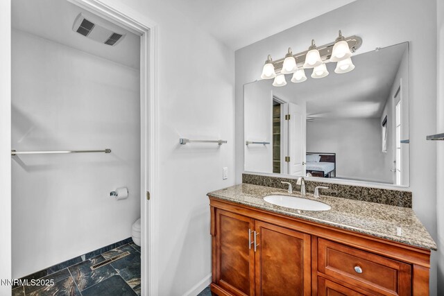 1129 Sonoma St, Carson City, NV 89701 - ensuite bathroom featuring vanity, toilet, and baseboards