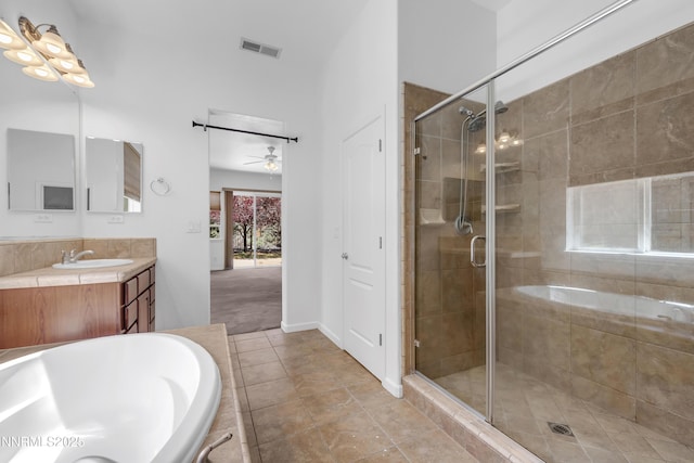 8355 Opal Ranch Way, Reno, NV 89506 - bathroom with vanity, a ceiling fan, a stall shower, a tub to relax in, and tile patterned flooring