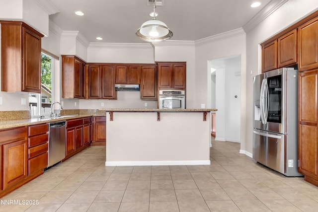 8355 Opal Ranch Way, Reno, NV 89506 - kitchen with appliances with stainless steel finishes, a sink, under cabinet range hood, light stone counters, and ornamental molding
