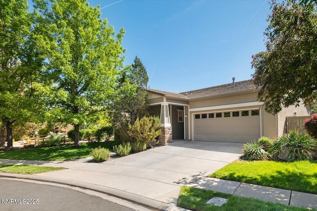 10548 Bliss Ct, Reno, NV 89521 - view of front of home featuring an attached garage, stucco siding, driveway, and stone siding