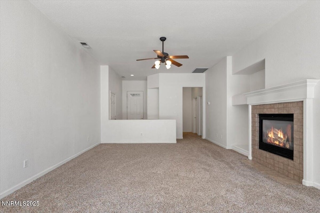 10548 Bliss Ct, Reno, NV 89521 - unfurnished living room featuring a ceiling fan, carpet floors, a tiled fireplace, and baseboards
