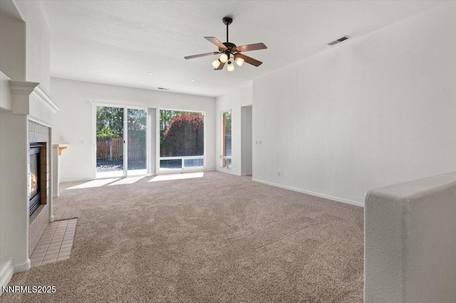 10548 Bliss Ct, Reno, NV 89521 - unfurnished living room featuring light carpet, ceiling fan, a tile fireplace, and baseboards