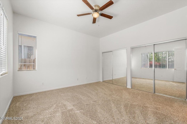 10548 Bliss Ct, Reno, NV 89521 - unfurnished bedroom with carpet floors, multiple closets, baseboards, and ceiling fan