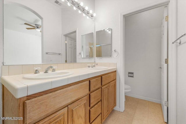 10548 Bliss Ct, Reno, NV 89521 - full bath with double vanity, toilet, and ceiling fan
