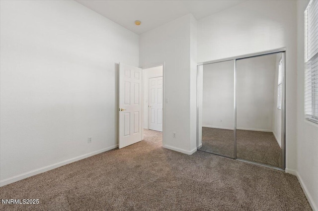 10548 Bliss Ct, Reno, NV 89521 - unfurnished bedroom featuring carpet floors, a closet, baseboards, and a high ceiling